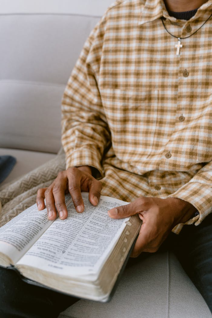 brand-03 A close-up of a man reading a Bible, emphasizing faith and reflection.